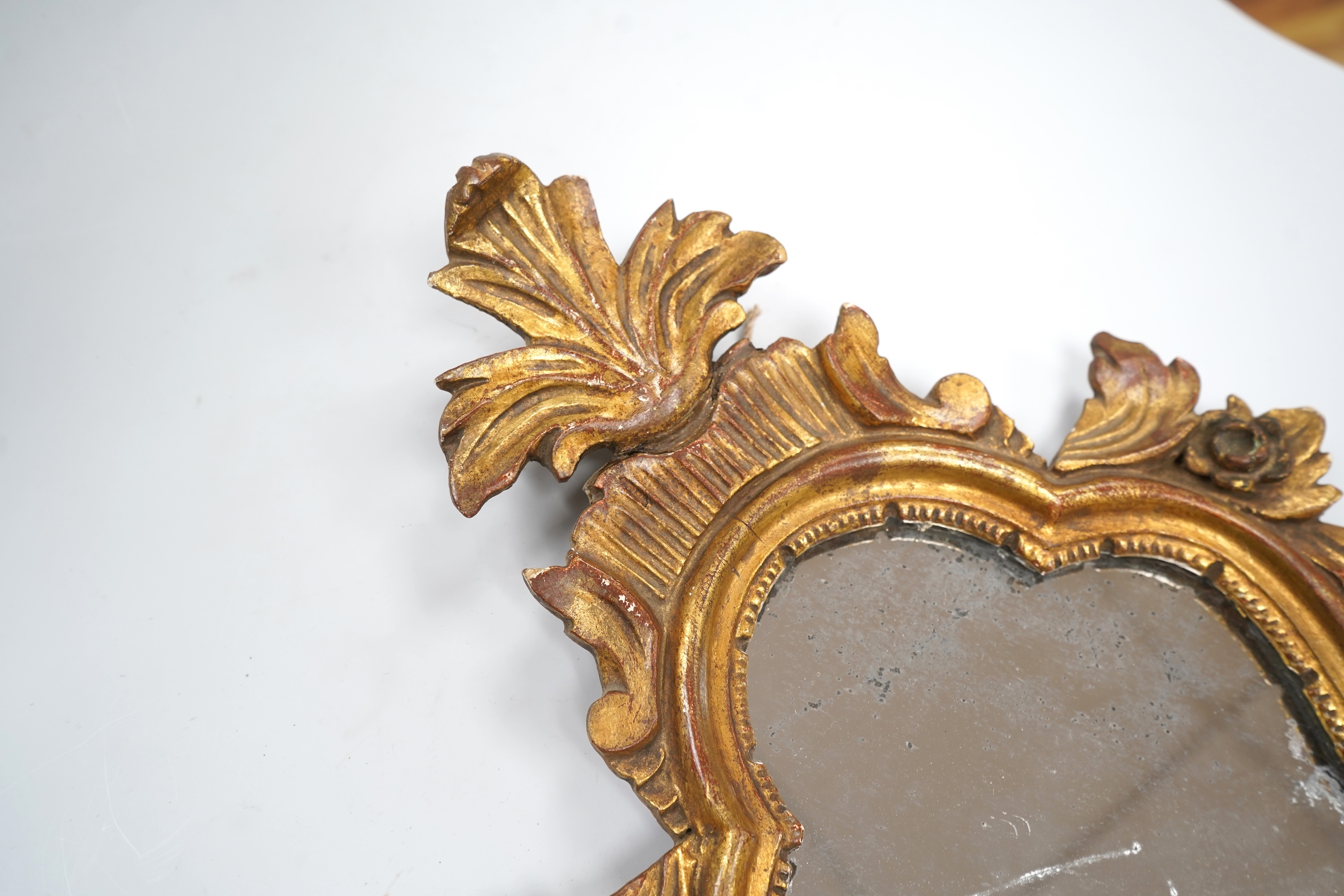 A small 19th century Italian carved giltwood mirror, 43cm high